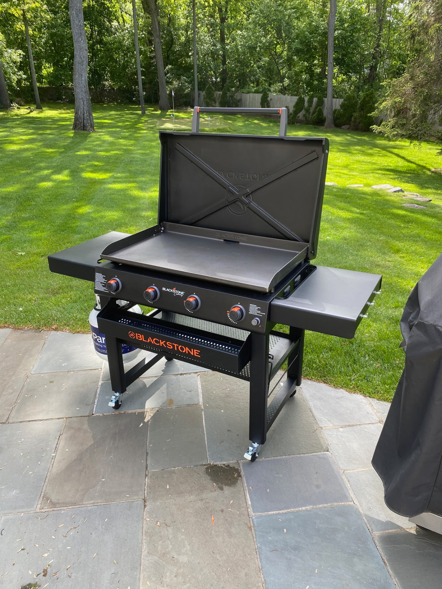 Assembled Blackstone outdoor griddle cooking station on a stone patio