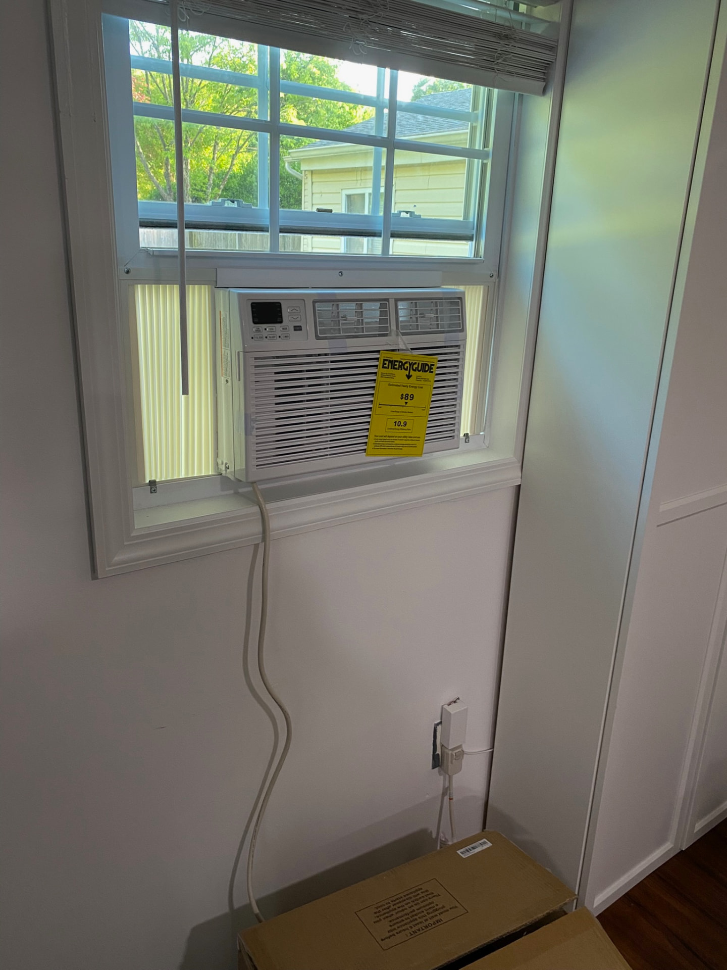 Window air conditioner installed securely in a double-hung window
