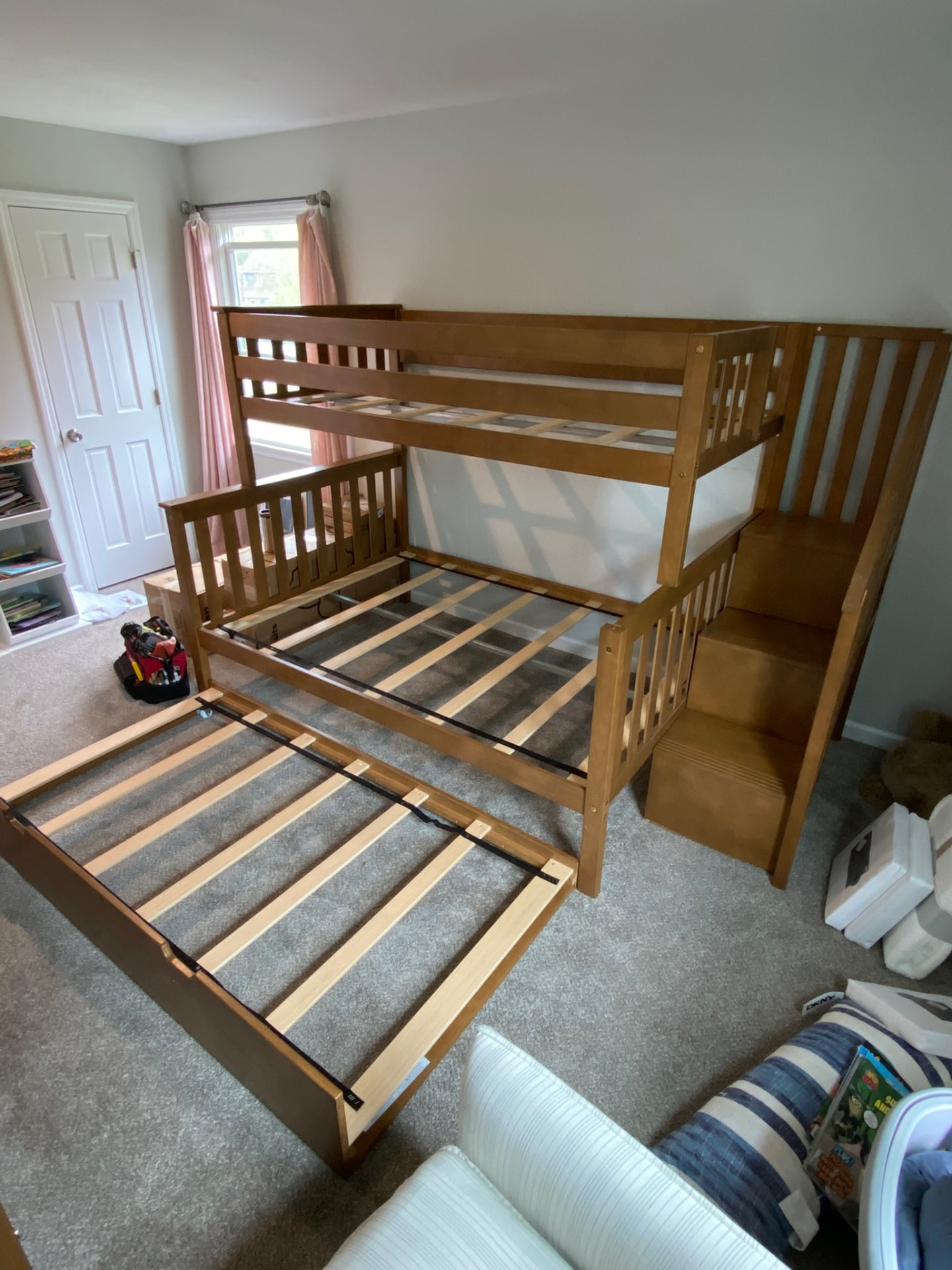 Assembled wooden bunk bed with stair storage and pull-out trundle bed