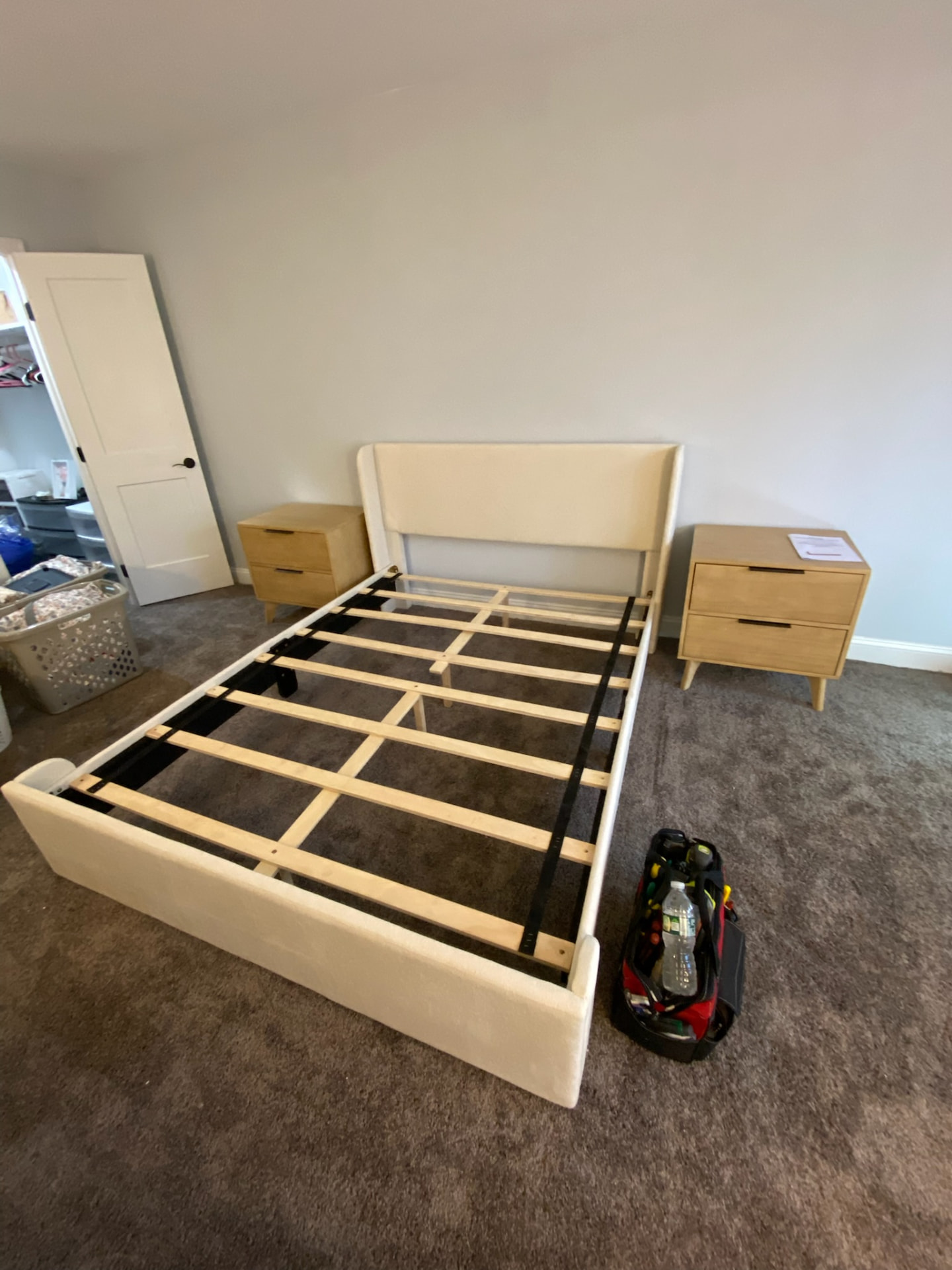 Assembled upholstered bed frame with two wooden nightstands