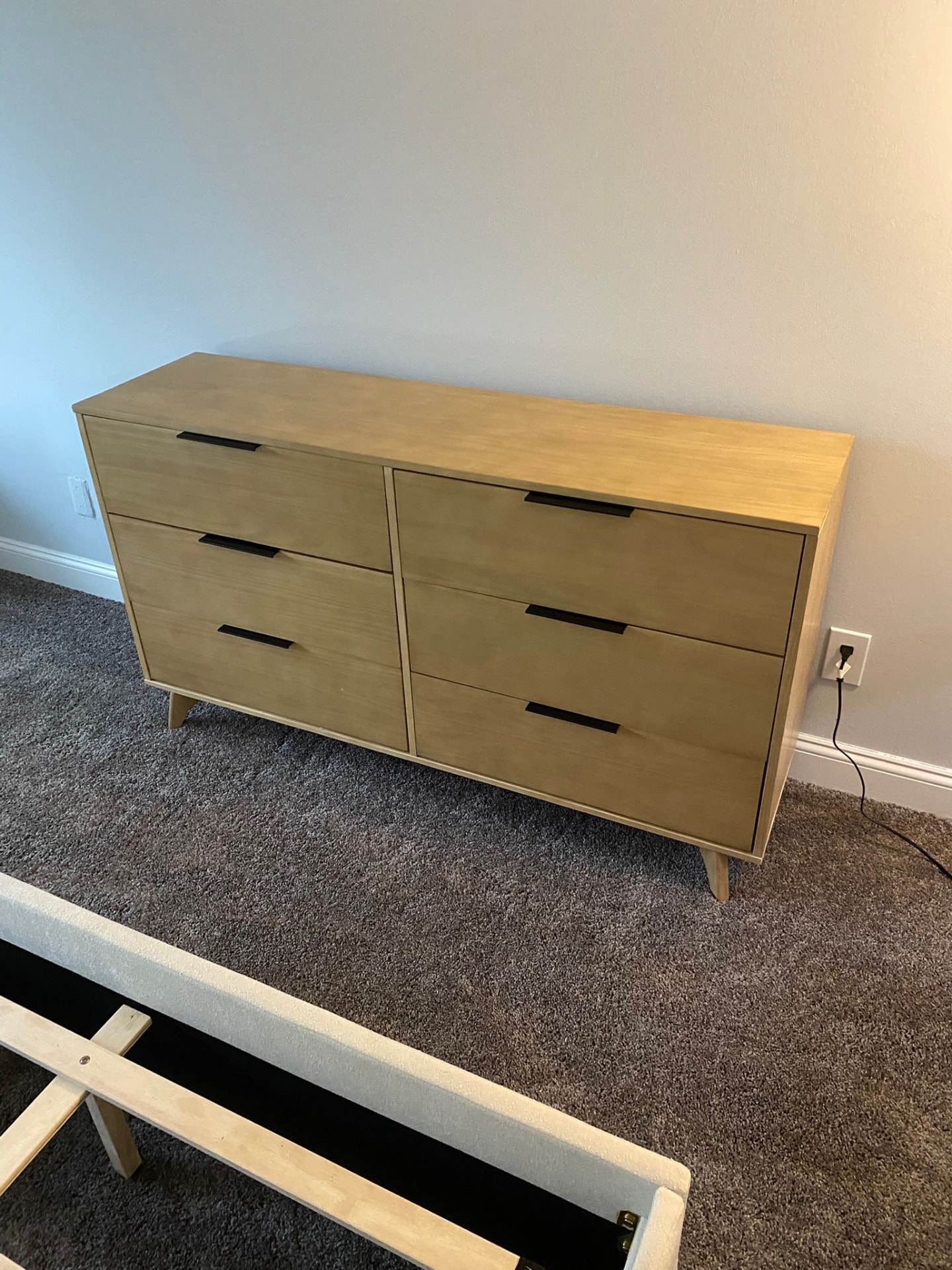 Assembled light wood six-drawer dresser with black handles