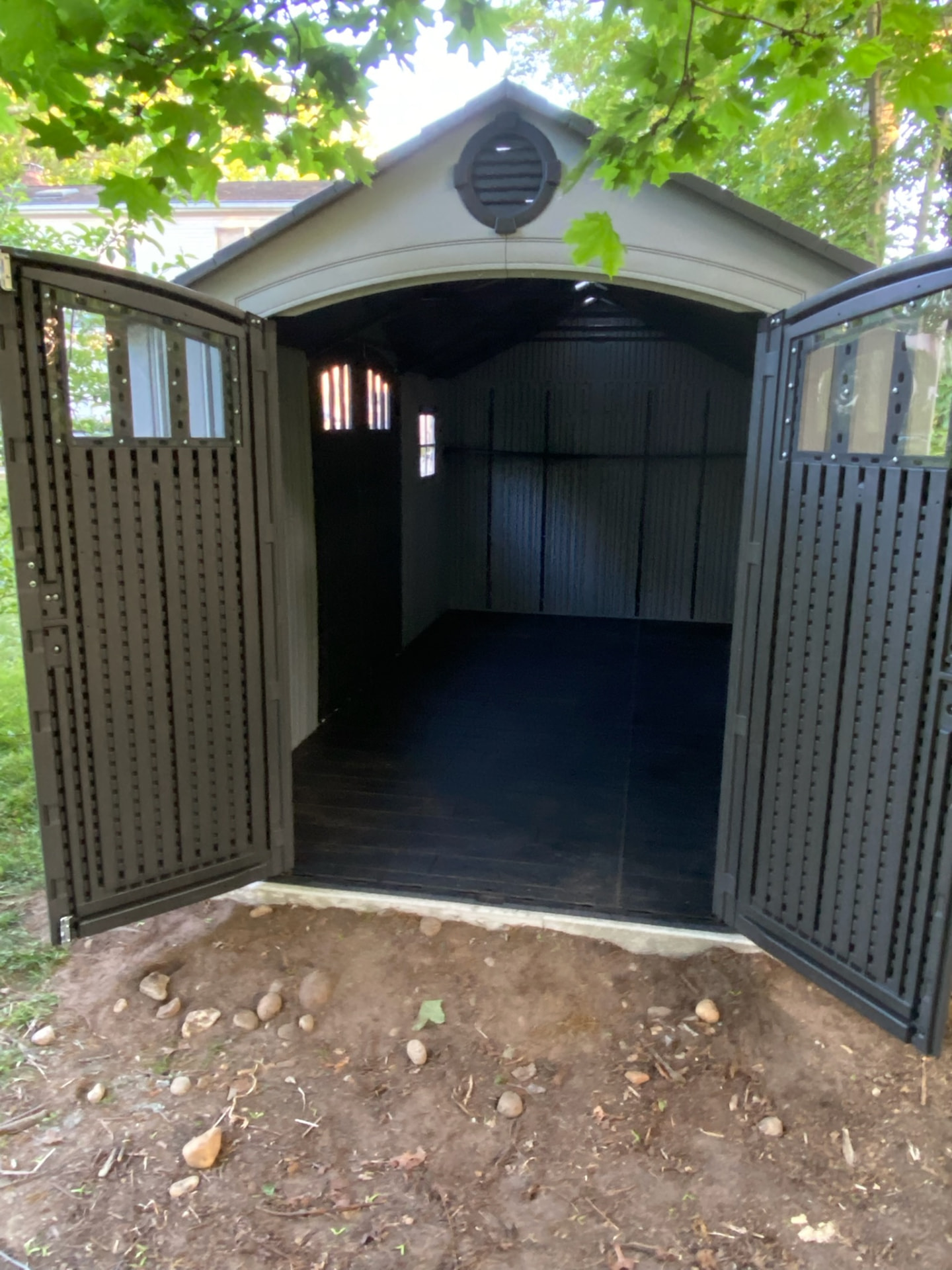 Interior of a completed storage shed with finished floor and walls
